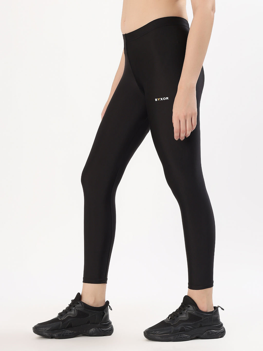 BYXOR Women's Leggings Black – Side walking view with sneakers